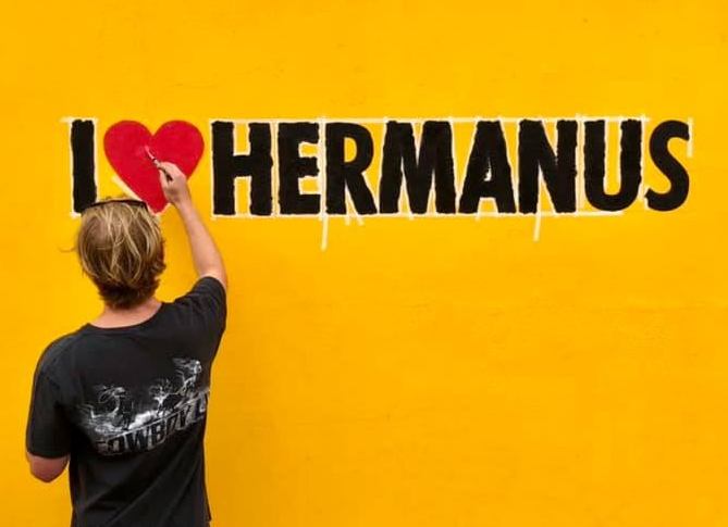 I ❤️ Hermanus painting on yellow wall, near Cape Town, South Africa